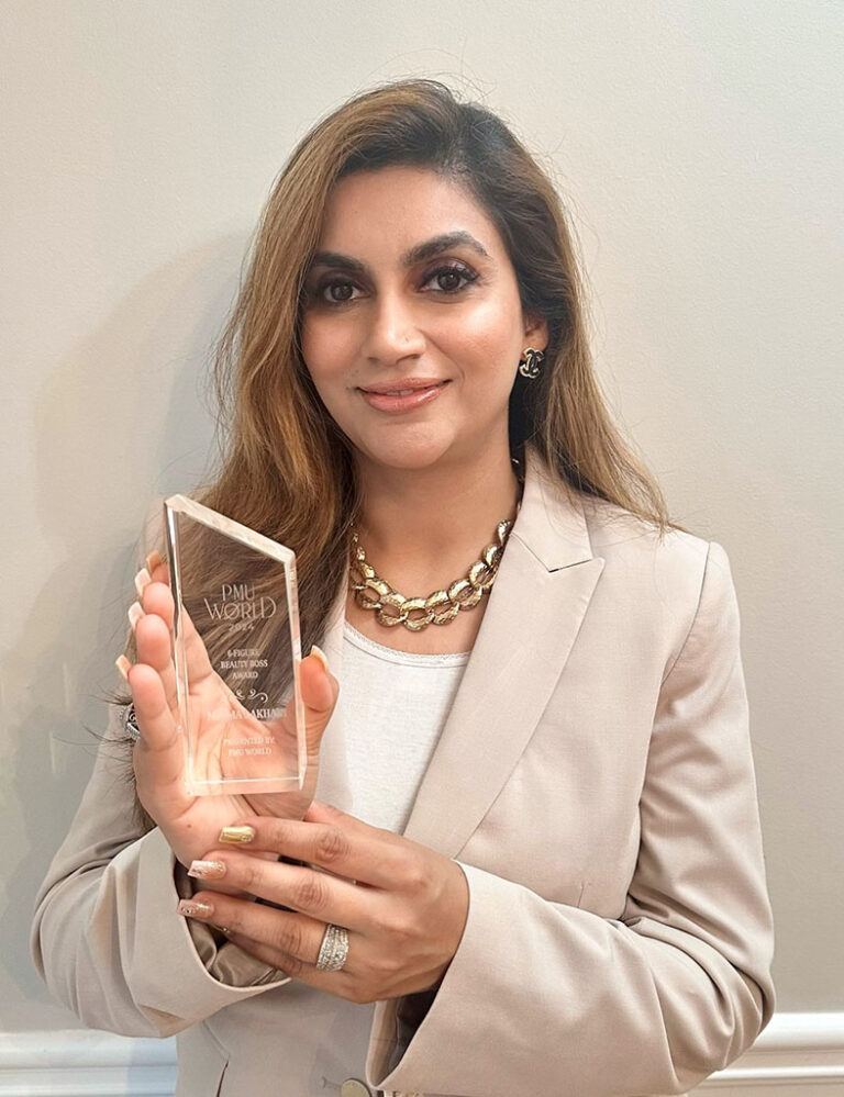 Niliny Lakhani holds the award